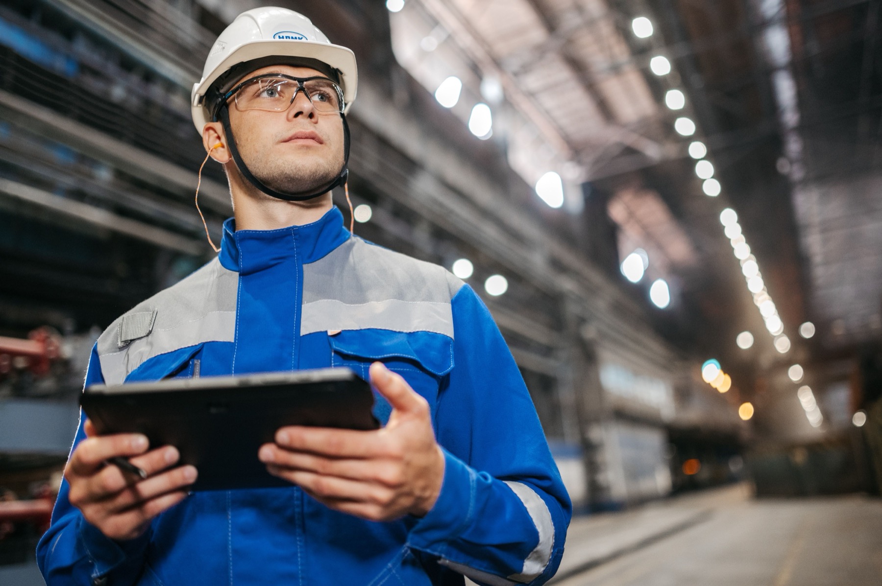 Technical worker using a digital tablet in an industrial environment
